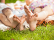 Girls Laying In the Park Barefoot On A Blanket