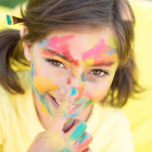 Little Girl Covered In Paint With Blue Nail Polish