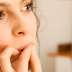 Brunette Woman Biting On Her Fingernails