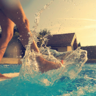 Woman Kicking Her Foot and Leg In Swimming Pool Water