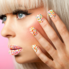 Woman With Colorful Cake Sprinkles On Her Fingernails and Lips