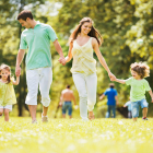 Family Running In A Grassy Park
