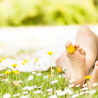 Barefoot Woman Lying In A Field Of Spring Flowers