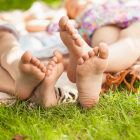 Girls Laying In the Park Barefoot On A Blanket