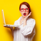 Woman Wearing Glasses Surprised By Something On Her Computer