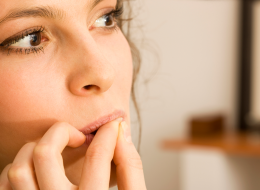 Brunette Woman Biting On Her Fingernails