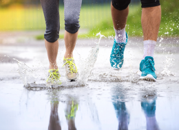 Couple Jogging Through Puddles In Bright Athletic Shoes