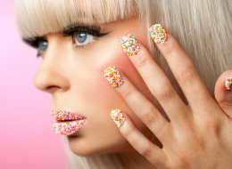 Woman With Colorful Cake Sprinkles On Her Fingernails and Lips