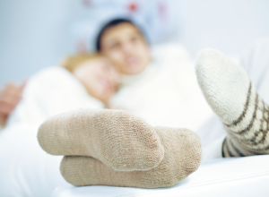 Couple wearing thick socks in bed