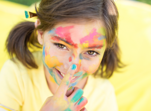 Little Girl Covered In Paint With Blue Nail Polish