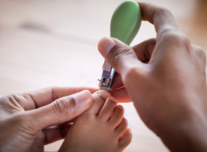 Mom Cutting A Baby&#039;s Toenails