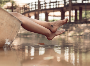 Woman In Boat With Anchor Foot Tattoo