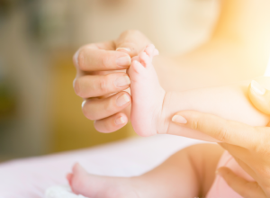 Mom caring for baby&#039;s foot