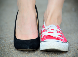 High heel shoe and sneaker side by side