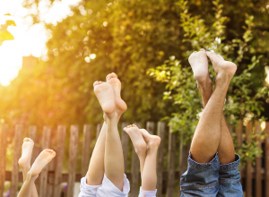 Man, Woman and Child Sticking Their Feet In The Air