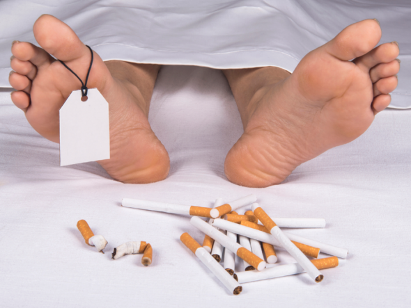 The Feet Of A Corpse Next To A Pile Of Cigarettes