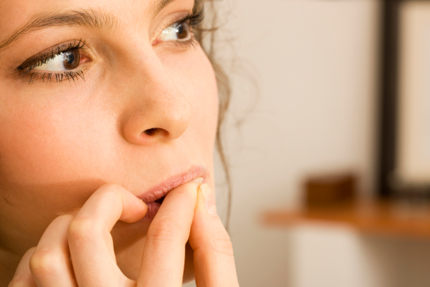 Brunette Woman Biting On Her Fingernails