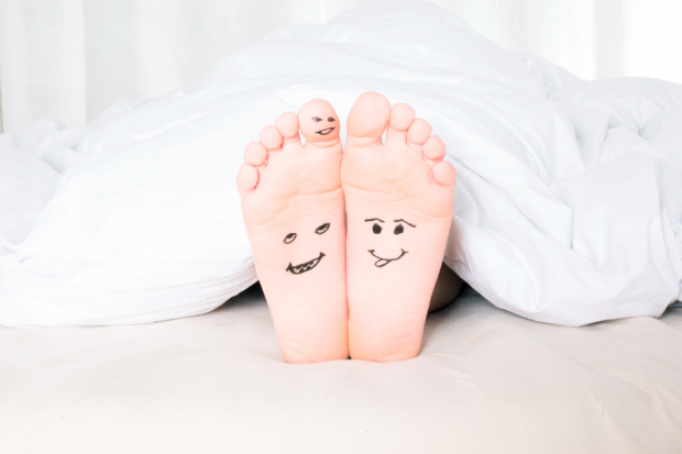 Feet with ink drawings of facial expressions