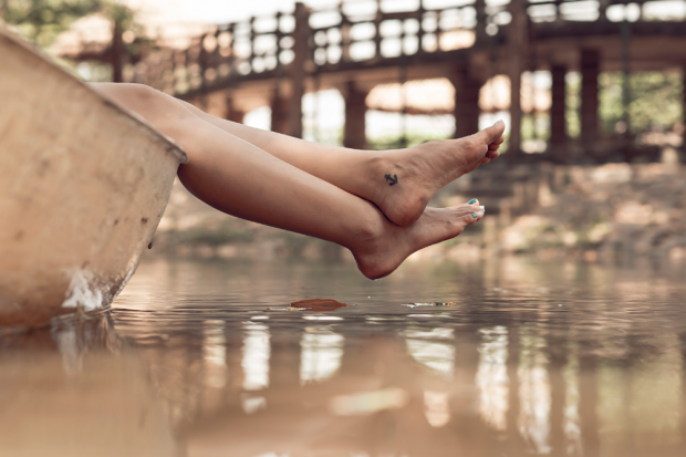 Woman In Boat With Anchor Foot Tattoo