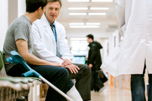 Man In A Cast Speaking With A Doctor 