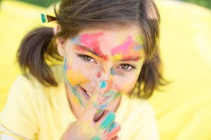 Little Girl Covered In Paint With Blue Nail Polish