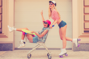 Two Girls Rollerskating Outside a Grocery Store