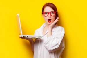 Woman Wearing Glasses Surprised By Something On Her Computer